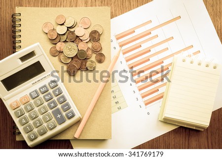 chart and money  on the wooden table with vintage color style