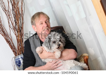 man with his dog on a sofa