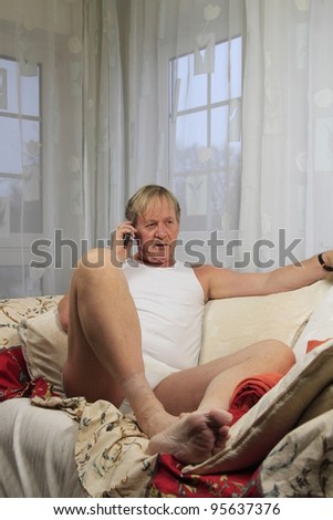 senior citizen in underwear while calling