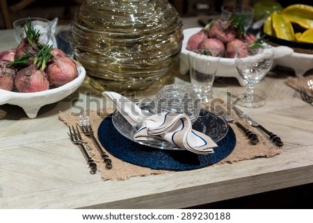 High-End Table Setting with Fine Cutlery, Glassware and Cloth Napkins