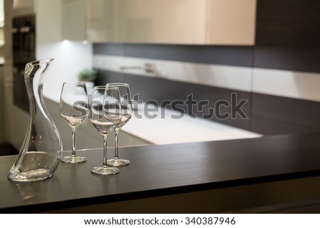 Empty Glasses and Wine Carafe in Stylish Modern Kitchen