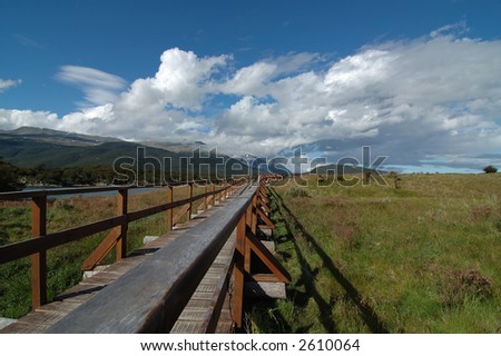 nature walk through landscape surrounded by mountains, water, plants