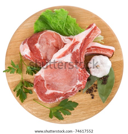 Fresh raw meat decorated with herbs and spices isolated on white background