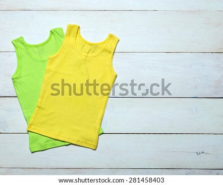bright knitted T-shirt on white wooden background