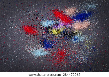 many colored powder paint makeup artistry abstract scattered on a black background