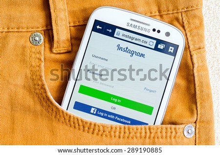 LVIV, UKRAINE - May 19, 2015: White Samsung Galaxy Smart Phone with Instagram social network Log In Screen in orange jeans pocket
