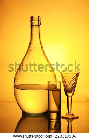 still life from glass subjects on a yellow background
