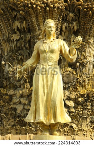 gold statue of the girl in a national suit