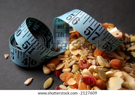 This is an image of a measuring tape and some country mix fruit/cereal.