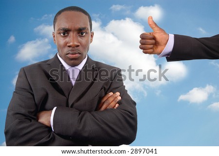 This is an image of an angry businessman who is trying to manage his anger. The thumbs up is a sign of encouragement. This image can be used to represent \