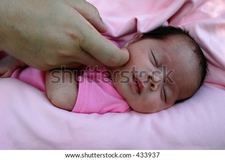 Preemie Baby Girl. caressing preemie baby.