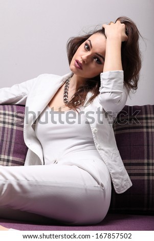 Elegant woman laying on the sofa. Fashion photo.