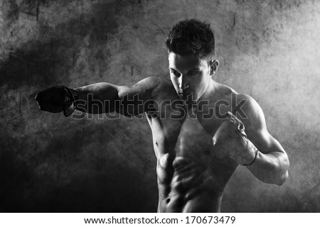 Portrait Of Boxer Posing In Studio In Gloves .Photo Has An Intentional Film Grain) .Fine Art.