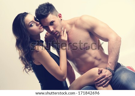 Happy young couple in sexual intercourse .Erotic photo, glamour colors.