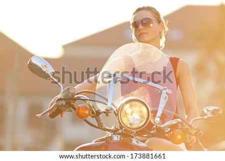 Portrait of smiling girl on scooter - Outdoor on street .Retro shot. Fashion art photo