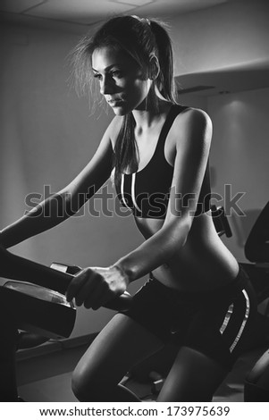 trainer at gym at class .Beautiful woman at the gym.Low light .B&W photo