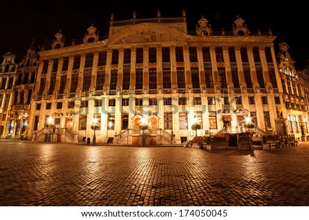 Wide angle night scene of the Grand Place, the focal point of Brussels, Belgium. The Town Hall (Hotel de Ville) is dominating the composition with its 96m tall spire.