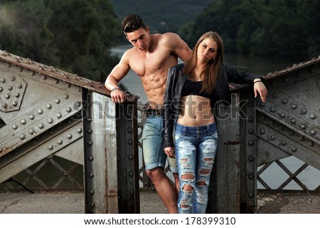 Outdoor natural portrait of a gorgeous couple fitness models.Fashion colors.