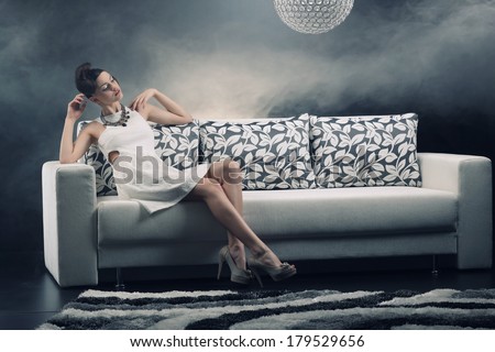 Young woman is lying on a couch .Fashion photo.