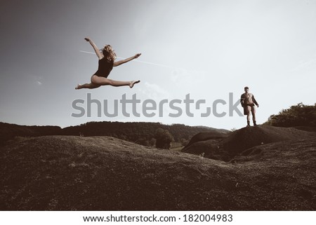 Outdoor natural portrait of a gorgeous couple fitness models.Gymnastics girl.Fashion colors.Wide angle.