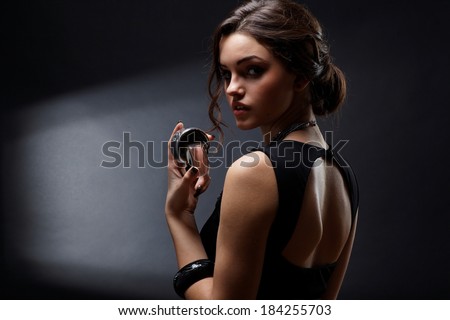 Elegant sensual young woman holding perfume, Fashion photo