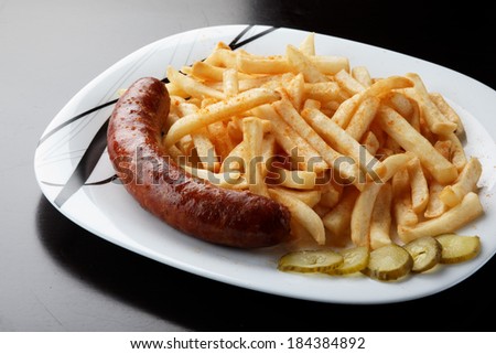 grilled sausage served with french fries