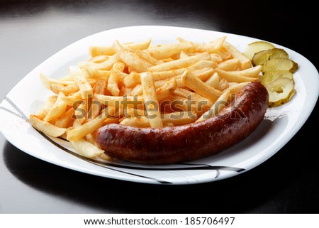 Grilled sausage served with french fries.
