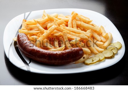 Grilled sausage served with french fries.