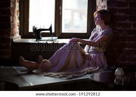 Fine art photo of a young fashion lady posing in old pub.