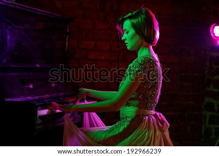 Pianist musician piano musical instrument playing. Music grand piano with woman performer. Fine art photo. Lowe light.