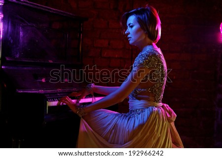Pianist musician piano musical instrument playing. Music grand piano with woman performer. Fine art photo. Lowe light.