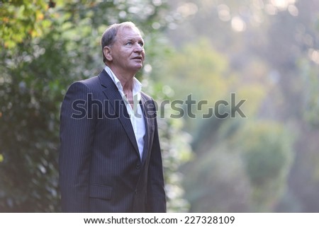 Portrait of a senior man outdoors. Young handsome smiling man outdoor portrait .
