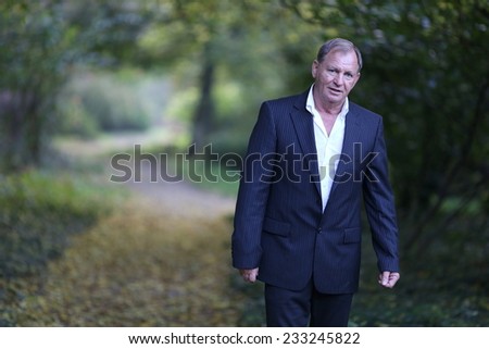 Portrait of a senior man outdoors. Young handsome smiling man outdoor portrait .