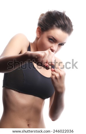 Sports girl, studio shot. isolated over white background.Sexy young and fit female fighter posing in combat poses