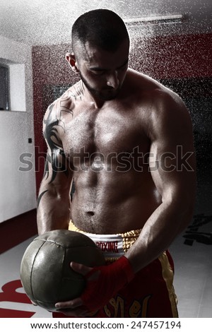 A Man With A Tattoo In Red Boxing Gloves -