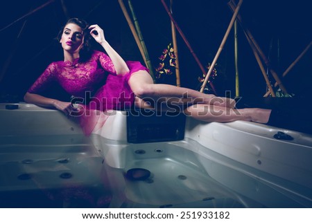 Glamour lady portrait in luxury dress. Beautiful model girl with perfect fashion makeup and hairstyle. Fine art photo of a sexy lady.Sexy young beauty posing.Sexy Glamour Girl posing in jacuzzi.
