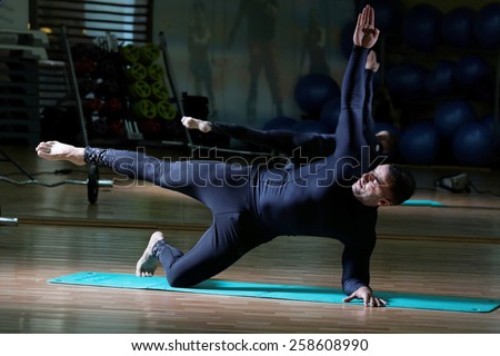 fusion of mind and body - man practicing pilates