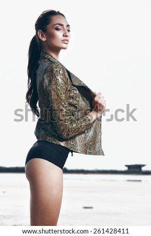 Outdoor summer portrait of young pretty cute brunette girl. Beautiful woman posing in desert. Young woman outdoors portrait