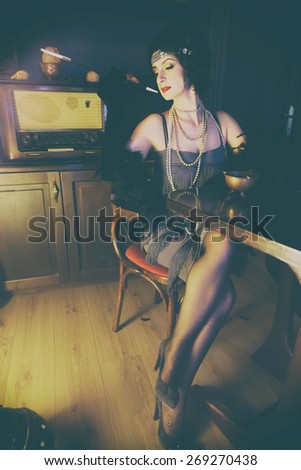 Retro girl with glasses of red wine in restaurant.Fashion,retro, vintage, tones. Antique picture.