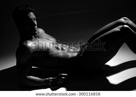Sexy portrait of a very muscular male model in sensual pose.