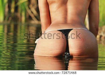 stock photo sexy ass woman in water at sunset