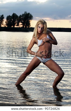 suddenly Subdivide Referendum A blonde bikini model posing against a setting sun on a body of water -  Stock Image - Everypixel