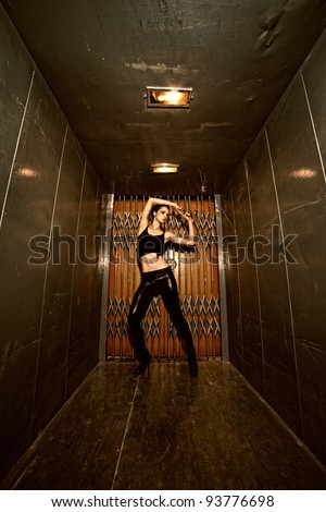 Brunete girl with a sexy back posing in elevator. Erotic art photo.