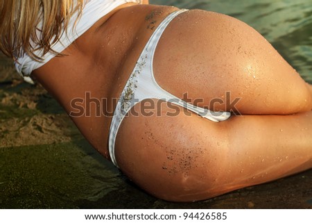 stock photo sexy ass woman in water at sunset