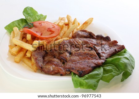 Juicy grilled pork chop (neck cut) with french fries