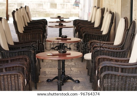 Empty restaurant chairs and tables in an old street in Montenegro