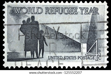 UNITED STATES OF AMERICA - CIRCA 1960: A stamp printed in USA shows Refugee Family walking toward New Life, with inscription and name of series \