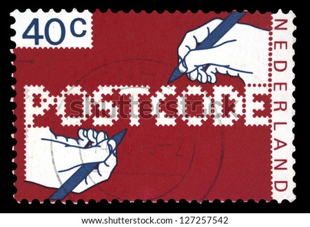 NETHERLANDS - CIRCA 1978: A stamp printed in Netherlands shows hands that write Postcode, with the inscription 