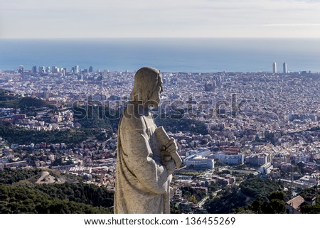 Statue of apostle observing city of Barcelona from top of Expiatory Church of the Sacred Heart of Jesus (Temple Expiatori del Sagrat Cor) on summit of Mount Tibidabo in Barcelona, Catalonia, Spain.