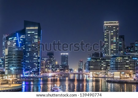DUBAI UAE SEPTEMBER 29 Night view at modern skyscrapers in Dubai Marina on September 29 2012 in Dubai UAE Marina artificial canal city carved along a 3 km stretch of Persian Gulf shoreline DUBAI UAE SEPTEMBER 29 Night view at modern skyscrapers in Dubai Marina on September 29 2012 in Dubai UAE Marina artificial canal city carved along a 3 km stretch of Persian Gulf shoreline